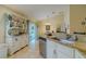 Well-lit kitchen featuring a granite countertop, white cabinets, and an adjacent dining area at 12854 Sw 77Th Cir, Ocala, FL 34473