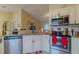 Modern kitchen featuring stainless steel appliances, granite countertops and bright, neutral colors at 12854 Sw 77Th Cir, Ocala, FL 34473