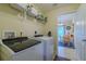 The laundry room features modern appliances and a view of the adjacent dining area at 12854 Sw 77Th Cir, Ocala, FL 34473
