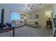 Bright living space with plush carpeting, vaulted ceilings, and comfortable furnishings at 12854 Sw 77Th Cir, Ocala, FL 34473