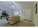 Comfortable living area featuring tile flooring, comfortable seating, and a ceiling fan at 12854 Sw 77Th Cir, Ocala, FL 34473