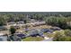 This aerial shows the home in a peaceful neighborhood, with a backdrop of a dense tree line at 12854 Sw 77Th Cir, Ocala, FL 34473