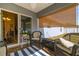 View of patio featuring wicker furniture and view into the dining room at 12854 Sw 77Th Cir, Ocala, FL 34473