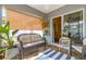 Comfortable screened patio featuring wicker furniture and sliding door to the dining room at 12854 Sw 77Th Cir, Ocala, FL 34473