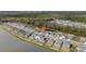 Aerial view showcasing a house's location in a community by a lake at 1856 Red Loop, Lakeland, FL 33801