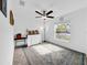 Bedroom with ceiling fan, window, and patterned rug at 1856 Red Loop, Lakeland, FL 33801