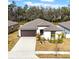 Single-story house with a two-car garage and landscaped lawn at 1856 Red Loop, Lakeland, FL 33801