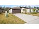 House exterior showcasing a driveway and two-car garage at 1856 Red Loop, Lakeland, FL 33801