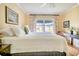 Bright bedroom featuring a king-size bed and a view at 457 Enright Pl, The Villages, FL 32162