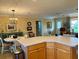 Kitchen island with seating and an open view of the dining area at 457 Enright Pl, The Villages, FL 32162