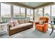 Relaxing sunroom with wicker furniture and a view of the backyard at 457 Enright Pl, The Villages, FL 32162