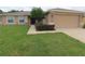 House exterior features a two-car garage and well-maintained lawn at 4852 Magnolia Preserve Dr, Winter Haven, FL 33880