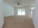 Spacious living room with carpeted floors and a ceiling fan at 4852 Magnolia Preserve Dr, Winter Haven, FL 33880