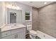 Bathroom with white vanity, tile shower, and gray tile at 6459 Sw 204Th Ave, Dunnellon, FL 34431