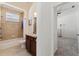 Bathroom with tub, granite vanity, and view into bedroom at 11276 Se 170Th Pl, Summerfield, FL 34491