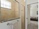 Bathroom with shower, granite vanity, and view into bedroom at 11276 Se 170Th Pl, Summerfield, FL 34491