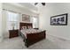 Spacious bedroom with carpeted floor, ceiling fan, and large windows at 11276 Se 170Th Pl, Summerfield, FL 34491