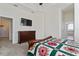 Comfortable bedroom with a dresser, large TV, and access to bathroom at 11276 Se 170Th Pl, Summerfield, FL 34491