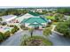 Aerial view of community center with green roof and ample parking at 11276 Se 170Th Pl, Summerfield, FL 34491