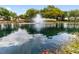 Community entrance with a fountain and pond at 11276 Se 170Th Pl, Summerfield, FL 34491