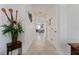 A view down a light-filled hallway with tile flooring at 11276 Se 170Th Pl, Summerfield, FL 34491