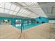 Indoor heated pool with high ceilings and plenty of natural light at 11276 Se 170Th Pl, Summerfield, FL 34491