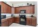 Corner kitchen features granite counters and wood cabinets at 11276 Se 170Th Pl, Summerfield, FL 34491