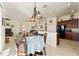 Open kitchen with island, granite counters, and breakfast nook at 11276 Se 170Th Pl, Summerfield, FL 34491