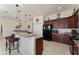 Modern kitchen with granite counters and black appliances at 11276 Se 170Th Pl, Summerfield, FL 34491
