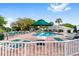 Community pool with lounge chairs and green umbrellas at 11276 Se 170Th Pl, Summerfield, FL 34491