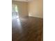 Bedroom with wood-look floors and door to patio at 1236 Ne 22Nd St, Ocala, FL 34470