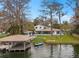 Lakeside home with a private boat dock, jet ski, and manicured lawn at 301 Rippling Ln, Winter Park, FL 32789