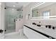 Modern bathroom with a double sink vanity and a frameless glass shower with marble tile surround at 301 Rippling Ln, Winter Park, FL 32789