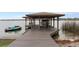 Private boat dock with a jet ski, a boat lift, and serene lake views at 301 Rippling Ln, Winter Park, FL 32789