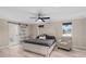 Main bedroom suite with sliding barn door to bathroom and light hardwood floors at 301 Rippling Ln, Winter Park, FL 32789