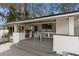 Outdoor kitchen with a grill, bar seating, and stainless steel appliances at 301 Rippling Ln, Winter Park, FL 32789