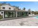 Spacious tiled patio with folding glass doors, a pool, and comfortable outdoor seating at 301 Rippling Ln, Winter Park, FL 32789