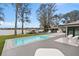 Beautiful pool area with outdoor seating, a lake view, a boat dock, and an outdoor kitchen at 301 Rippling Ln, Winter Park, FL 32789