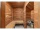 Wood paneled cedar sauna features built-in bench seating and a rock heating element at 301 Rippling Ln, Winter Park, FL 32789