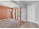 Dining room with tile floor, coral curtains, and chandelier at 2016 Sanderlin Point Loop, Apopka, FL 32703