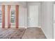 Bright entryway with tile flooring and coral curtains at 2016 Sanderlin Point Loop, Apopka, FL 32703