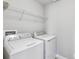 Bright laundry room with washer, dryer, and shelving at 2016 Sanderlin Point Loop, Apopka, FL 32703