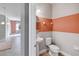 Small half bathroom with two-toned walls and round mirror at 2016 Sanderlin Point Loop, Apopka, FL 32703