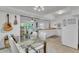 Kitchen and dining area with glass table, white chairs, and modern appliances at 270 N 1St St, Lake Mary, FL 32746