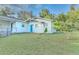 Side view of the house, showcasing a teal door and green lawn at 270 N 1St St, Lake Mary, FL 32746