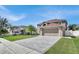 House exterior showcasing a large driveway and front yard at 11924 Pethrick Dr, Orlando, FL 32824