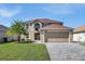 Two-story house with a large driveway and landscaped lawn at 11924 Pethrick Dr, Orlando, FL 32824