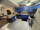 Kitchen boasts blue and grey cabinets, granite countertops and island at 1880 N Crystal Lake Dr # 57, Lakeland, FL 33801