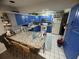 Kitchen with blue and grey cabinets, granite countertops, and an island at 1880 N Crystal Lake Dr # 57, Lakeland, FL 33801