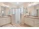 Bathroom with double vanity, a large shower, and light colored cabinets at 461 Troy Loop, The Villages, FL 32162